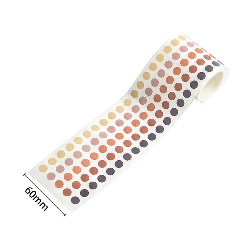 A roll of round color-coding dot stickers in warm neutral tones, shown with a 60mm width reference.