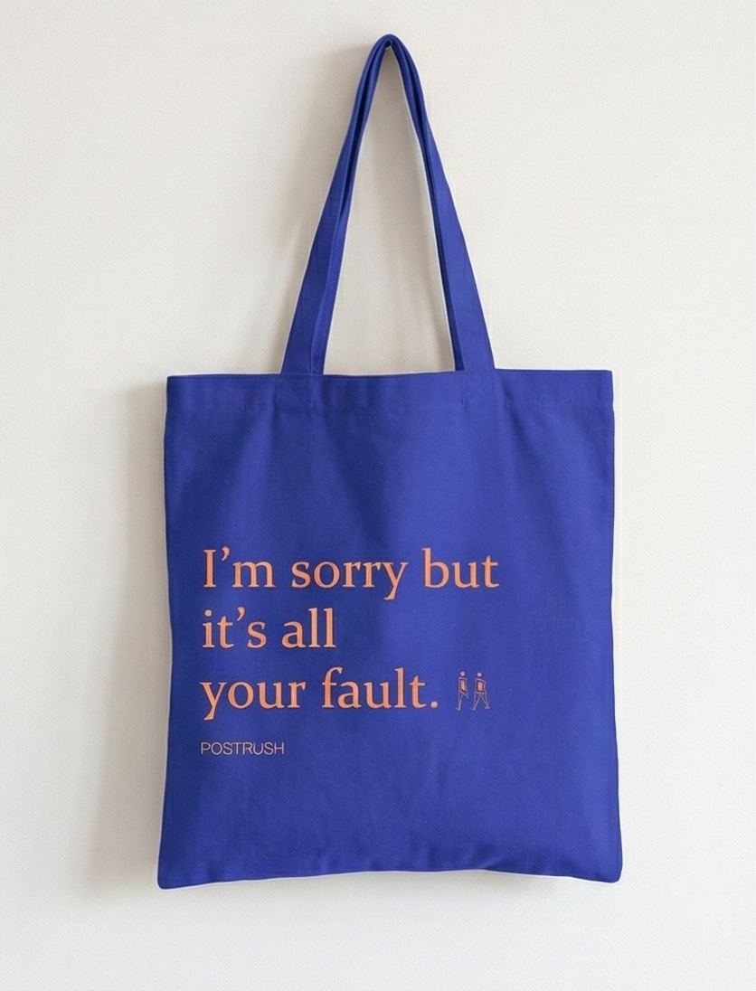 Blue tote bag with text 'I'm sorry but it's all your fault.' on a white background