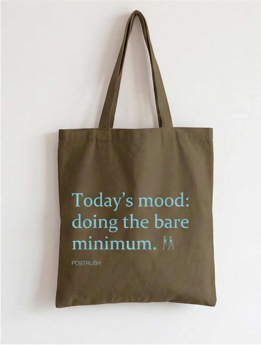 Brown tote bag with humorous text and branding on a white background
