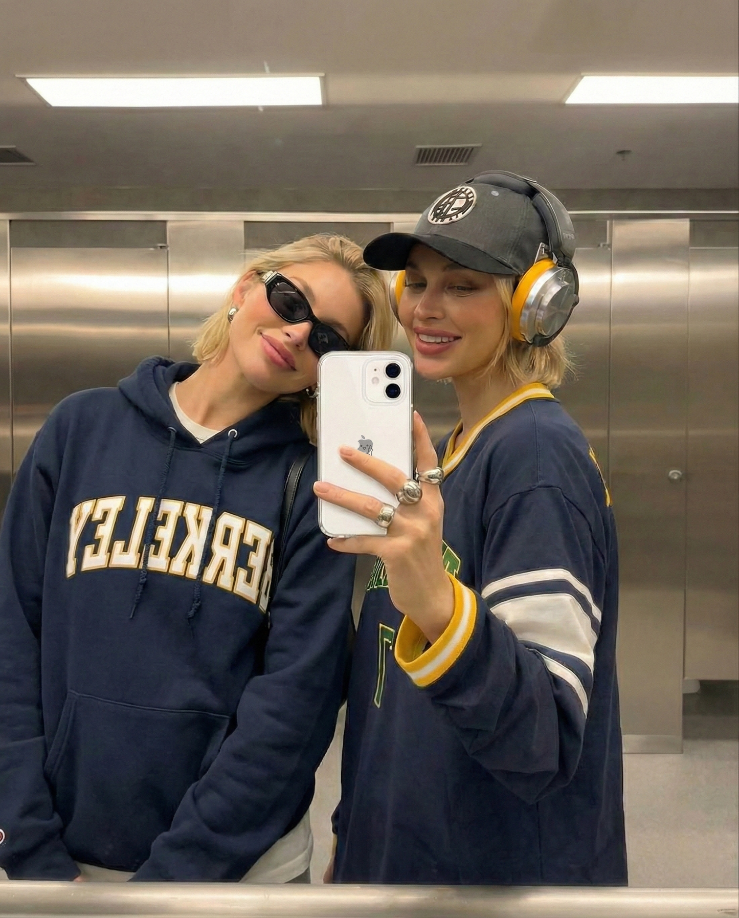 Mirror selfie showing a clear phone case in a casual streetwear setting.